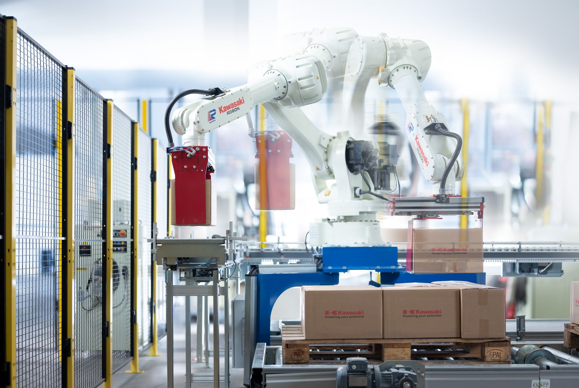 Kawasaki robots palletizing cases on a conveyor