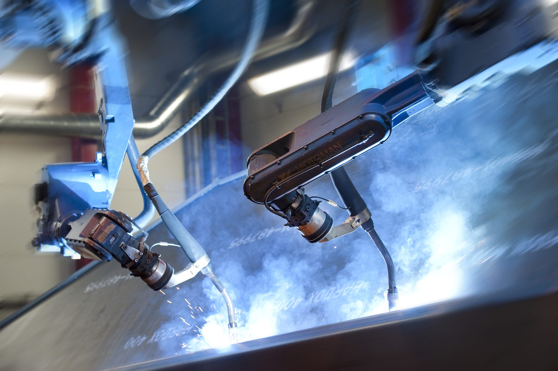 Motoman robots welding a steel part